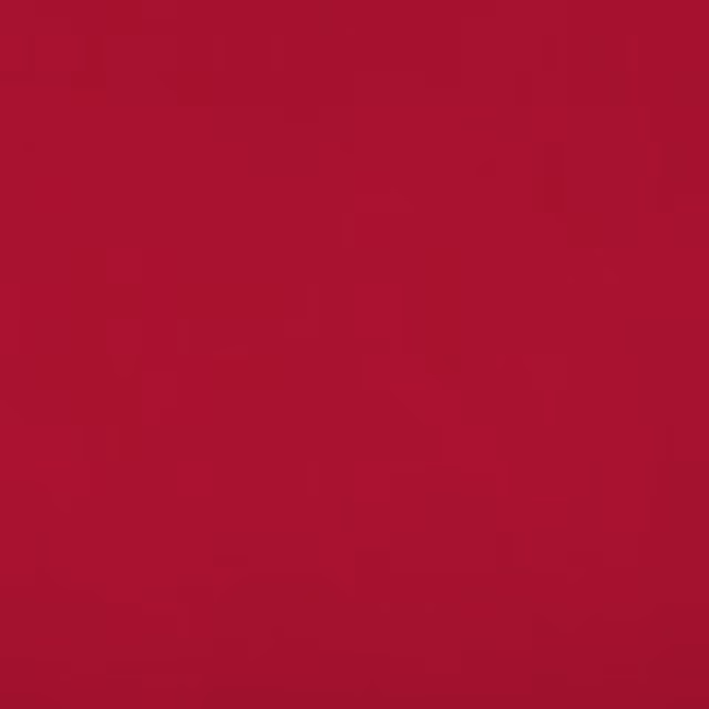 Close-up of smooth, deep raspberry-red fabric with subtle tonal grain