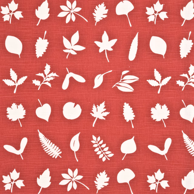 Warm red fabric with white silhouetted leaves, pods and flowers on a fine woven ground