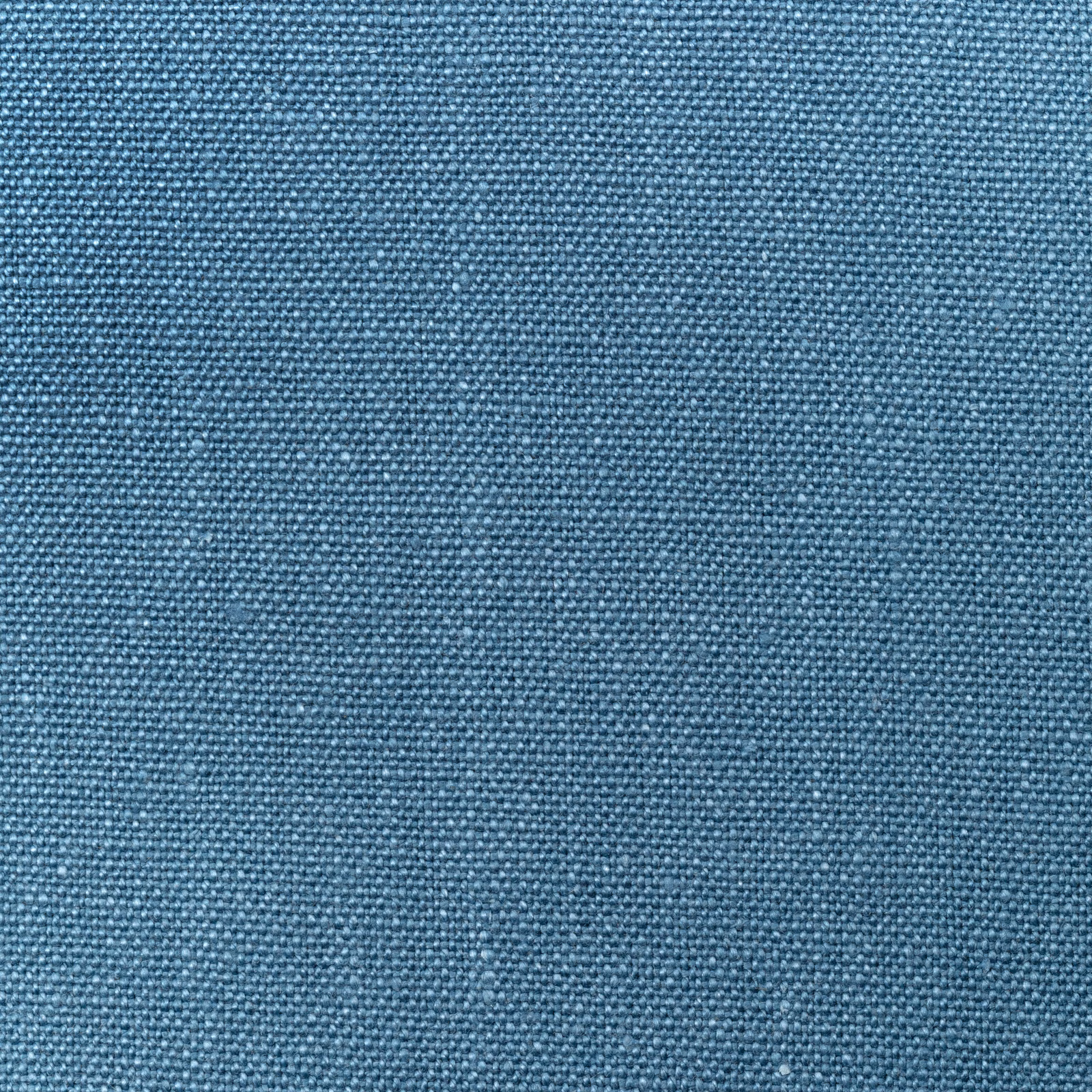Close-up of cool mid-blue linen with a dense, softly flecked plain weave