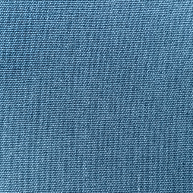 Close-up of cool mid-blue linen with a dense, softly flecked plain weave