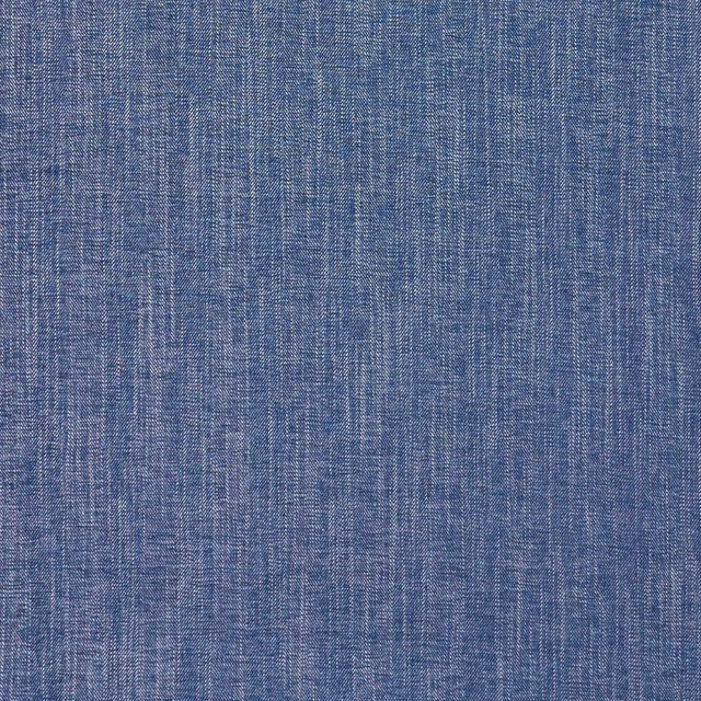 Close-up of muted denim-blue fabric with a dense, crosshatched woven texture