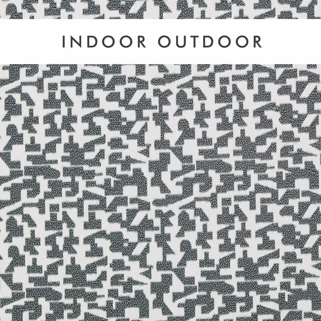 Cool charcoal geometric fragments woven across an ivory textured outdoor fabric swatch