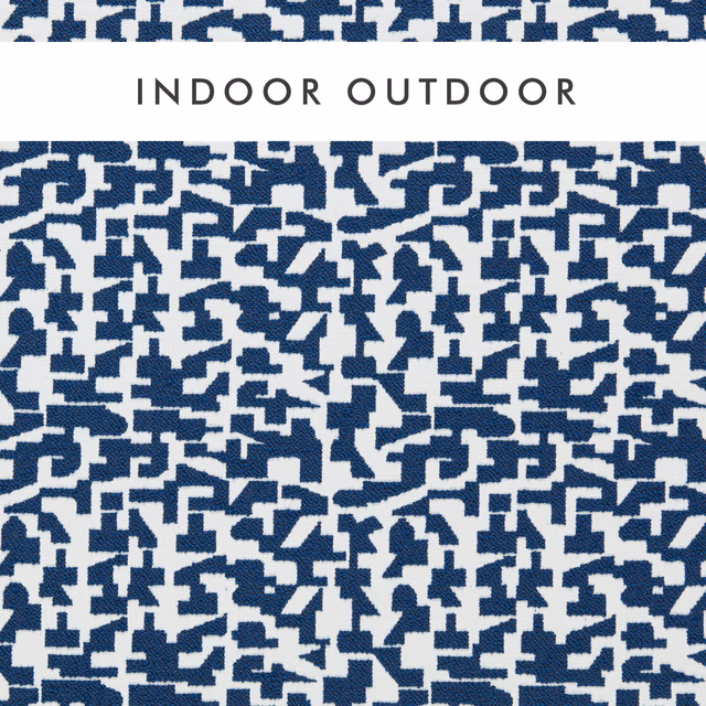 Midnight-blue fragmented geometric weave on an ivory ground, shown in close-up
