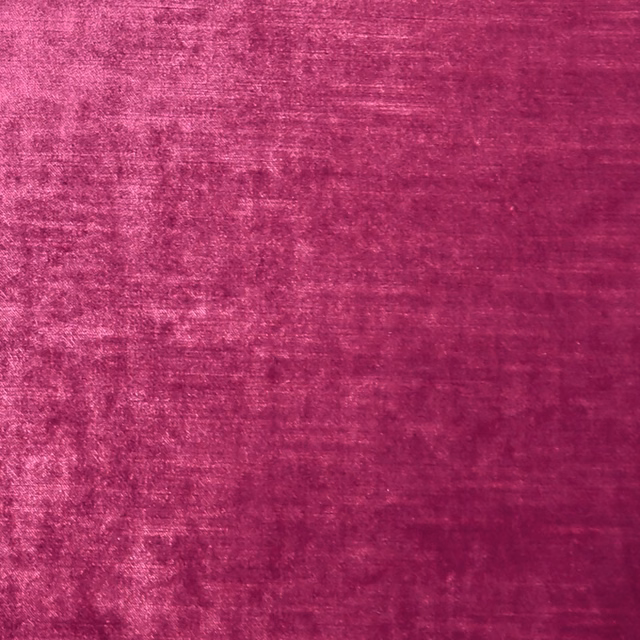 Deep magenta textile with a softly mottled, light-catching velvety pile