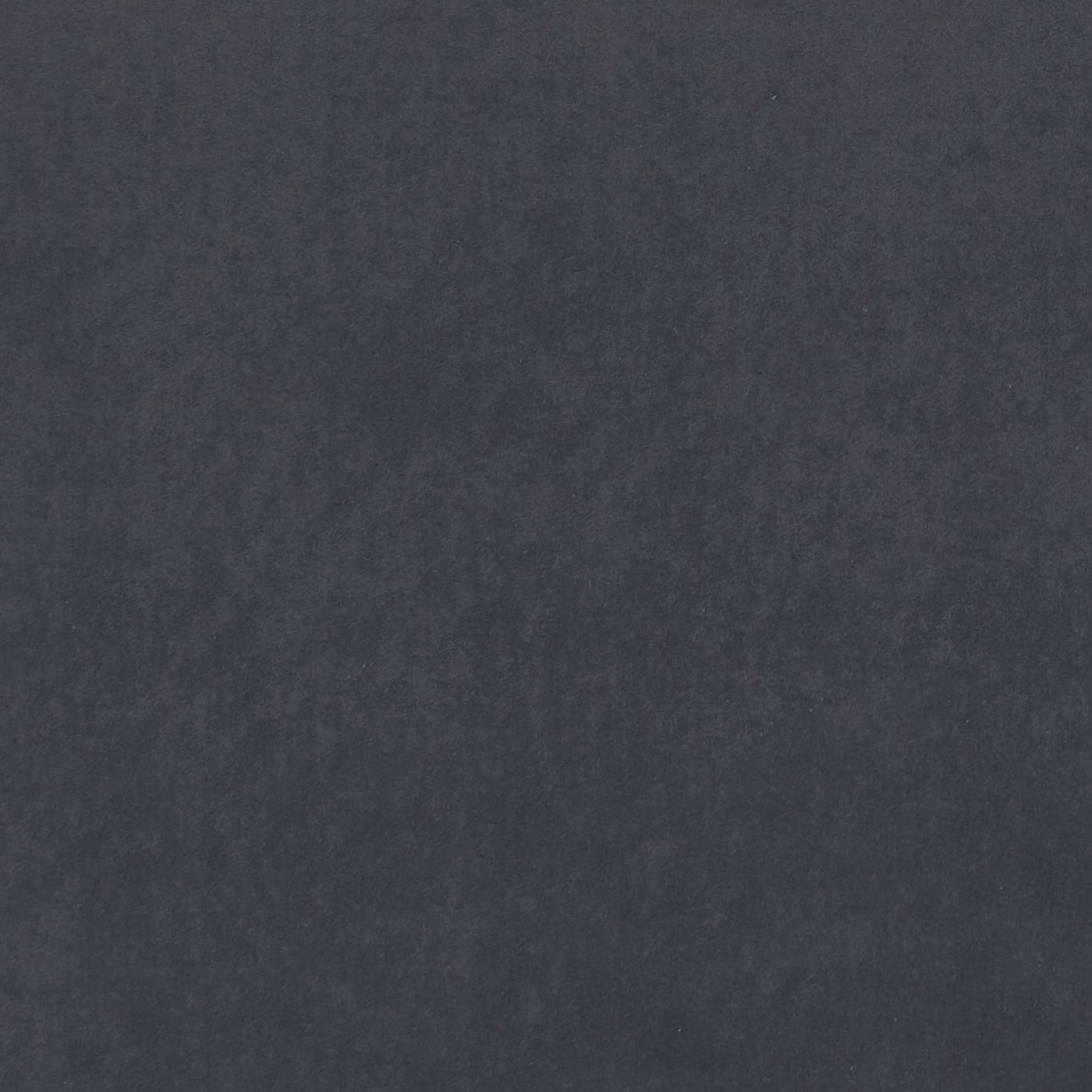 Close-up of dark graphite textile with subtle cloudy tonal variation and soft grain