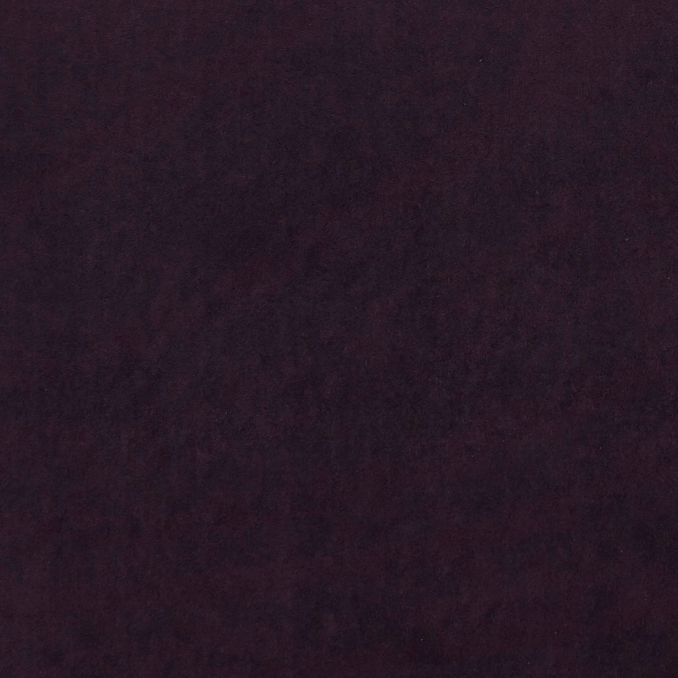 Close-up of deep mulberry plum fabric with subtle mottled shading and soft texture