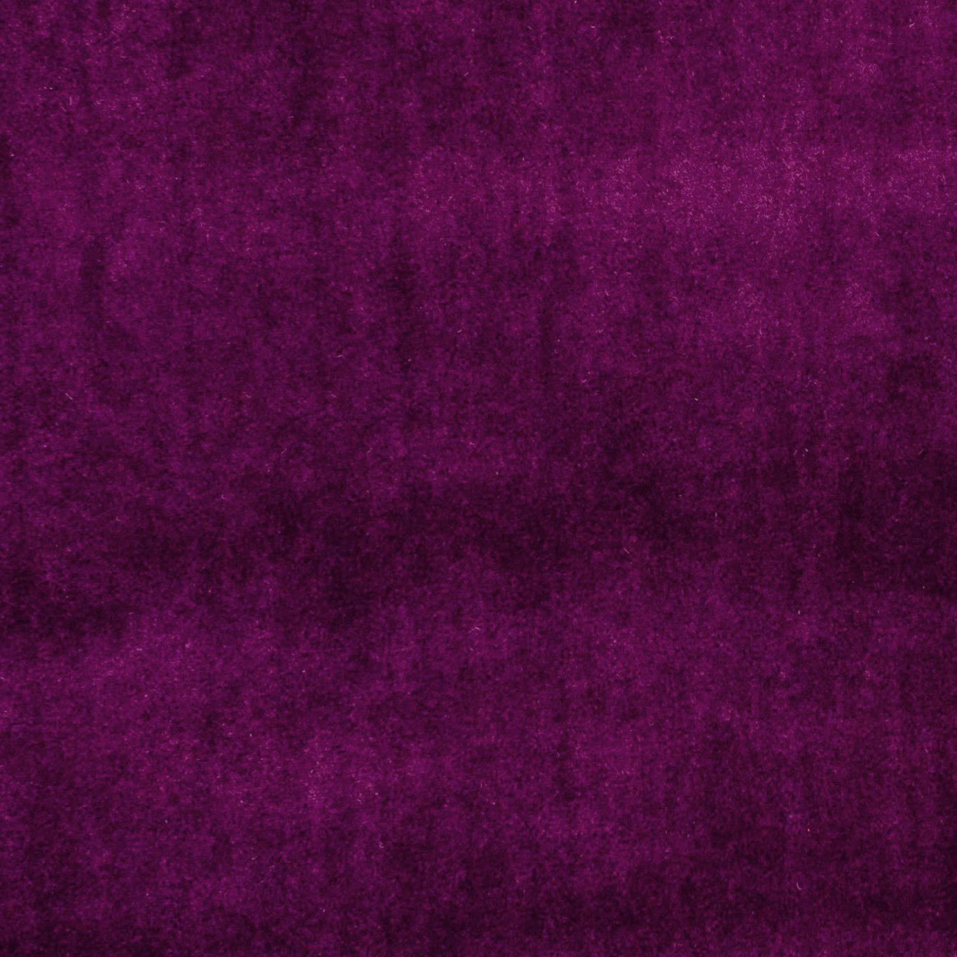 Deep plum-purple fabric with softly mottled, velvety texture and subtle tonal highlights