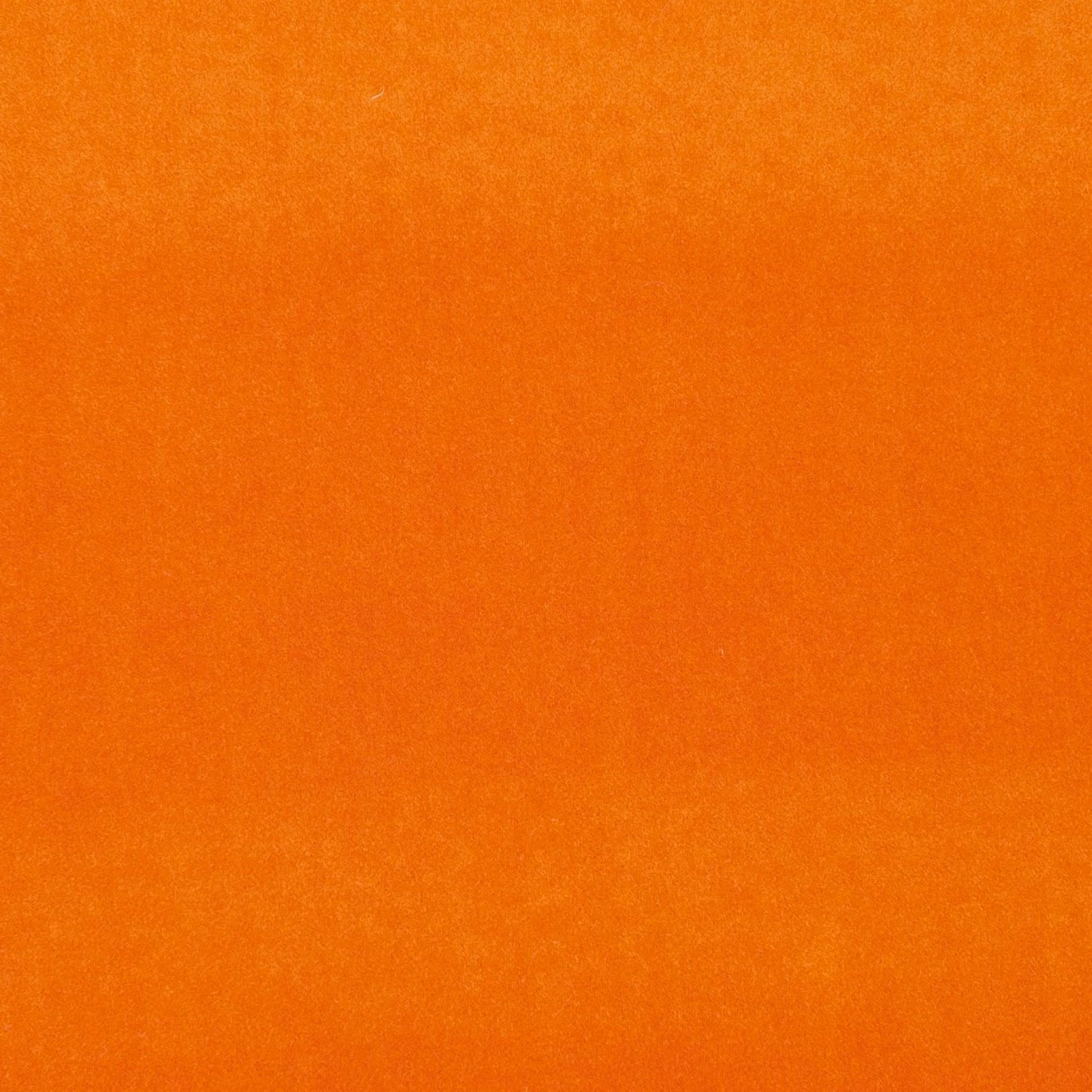 Warm sunset-orange fabric with subtle vertical nap and softly mottled surface texture