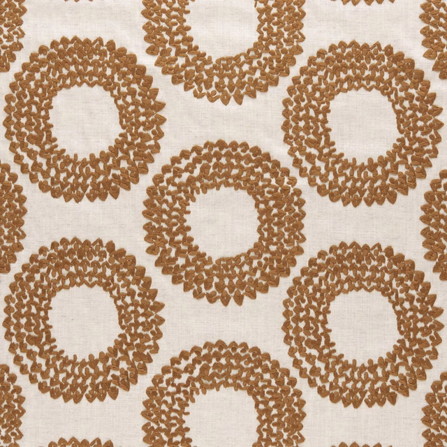 Ivory woven fabric with textured cinnamon-brown circular ring motifs