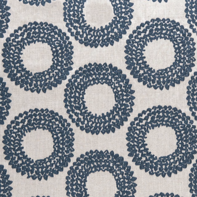 Cool indigo looped rings woven across a pale textured fabric ground