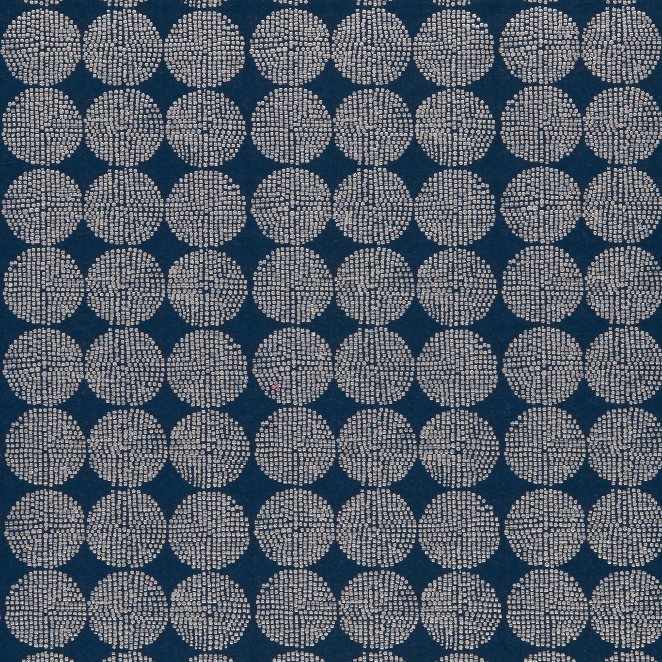 Deep indigo fabric with repeating ivory dotted circular medallions