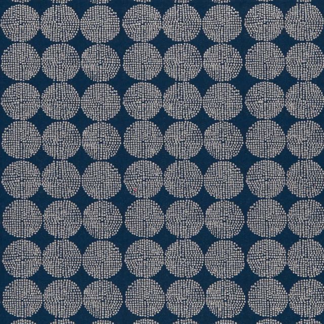 Deep indigo fabric with repeating ivory dotted circular medallions