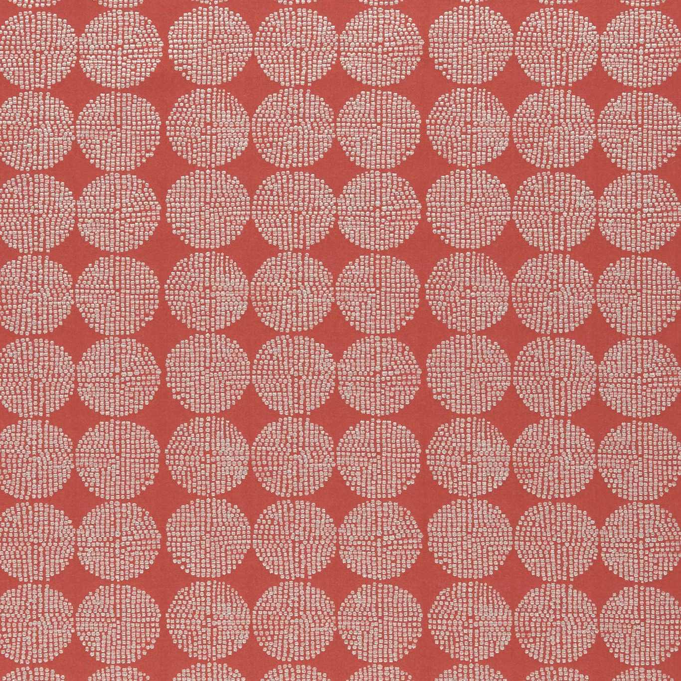 Warm brick-red textile with repeating ivory dotted circular motifs and tactile woven texture