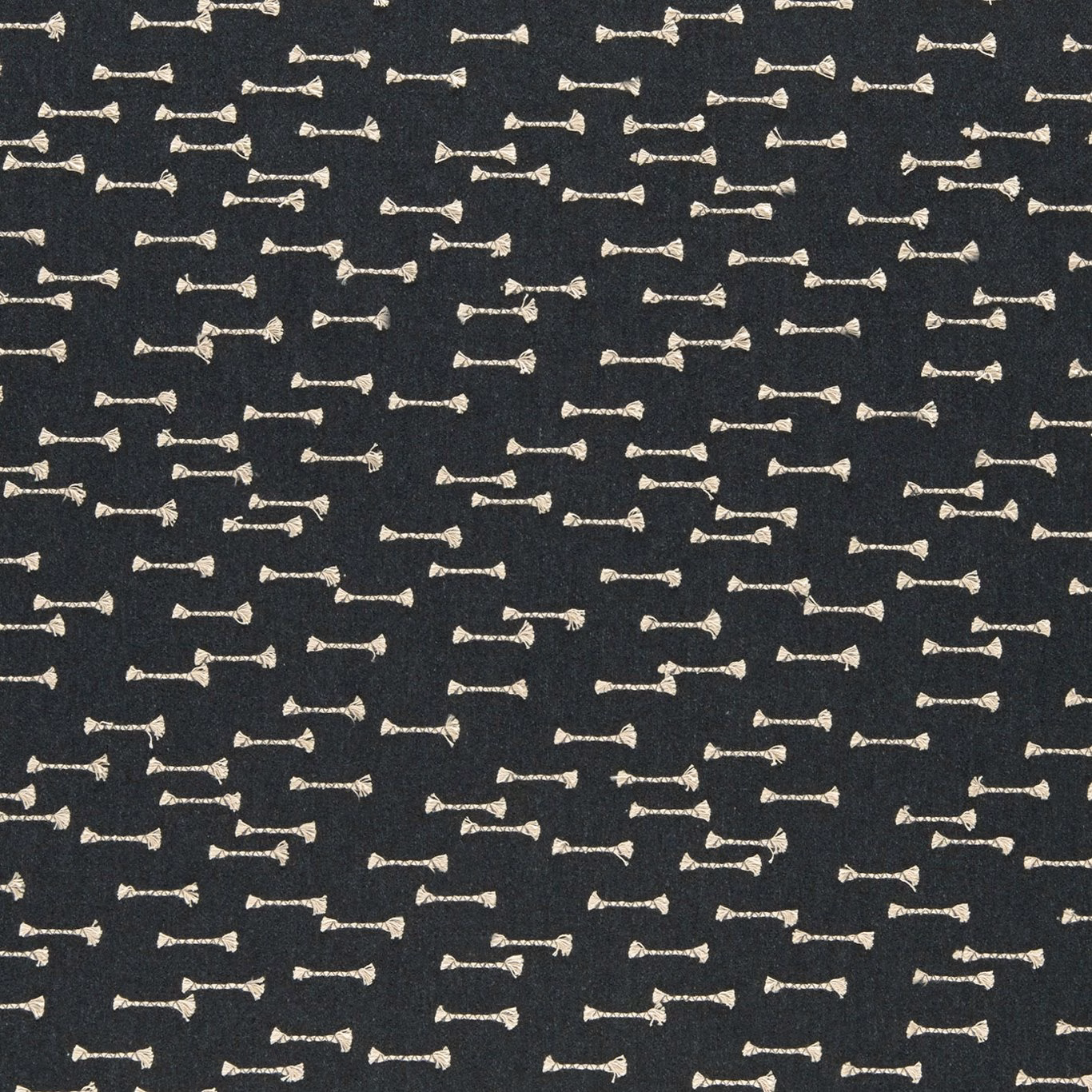 Charcoal woven upholstery with scattered small ivory bow-tie motifs and tactile texture