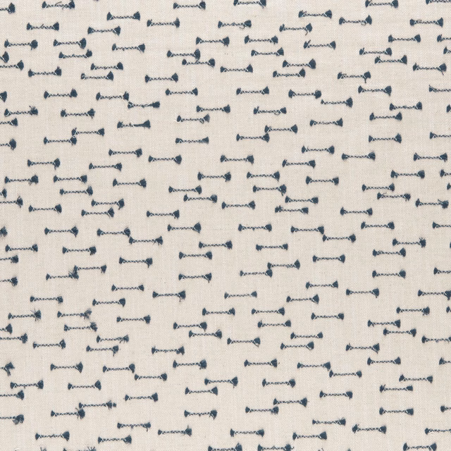 Cream woven ground with scattered small indigo bow-like motifs
