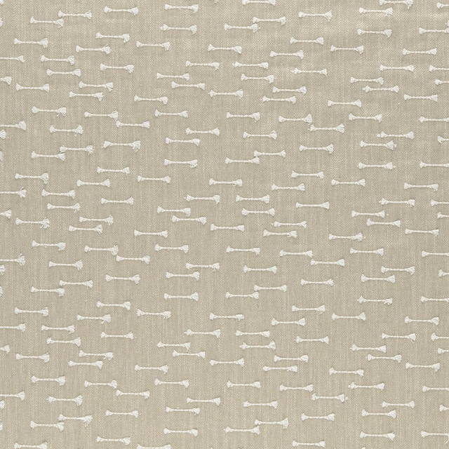 Warm beige woven fabric with small irregular ivory horizontal dash motifs