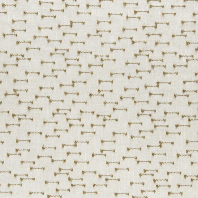 Warm ivory woven fabric with small willow-toned bow motifs and visible texture