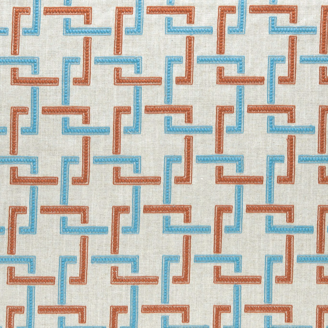 Cinnabar and aqua interlocking motifs woven across a pale cream ground