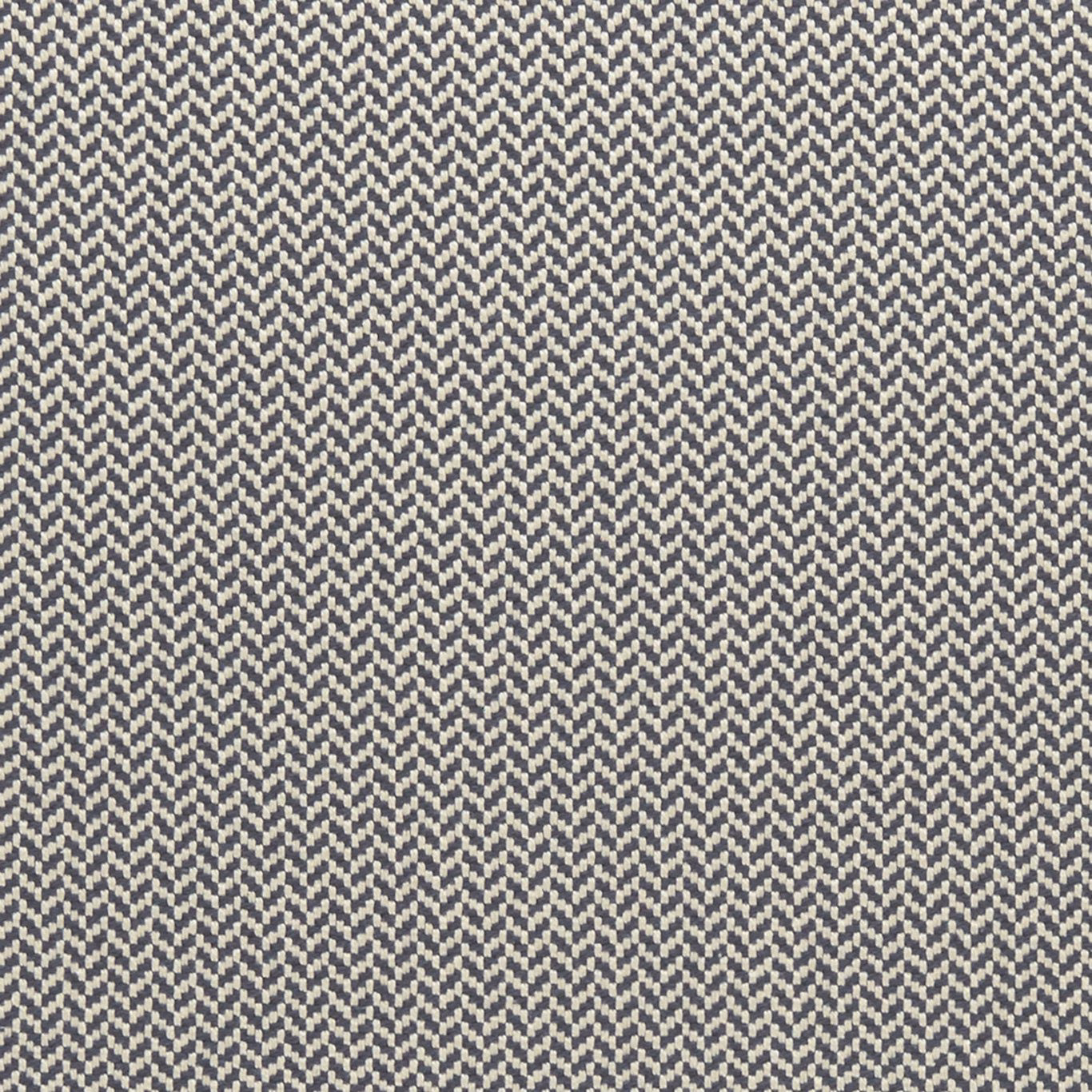 Close-up of muted indigo and ivory woven herringbone textile with dense zigzag texture