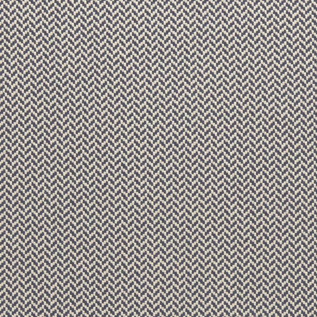 Close-up of muted indigo and ivory woven herringbone textile with dense zigzag texture