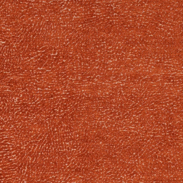Close-up of warm spice terracotta fabric with irregular pale flecked woven texture