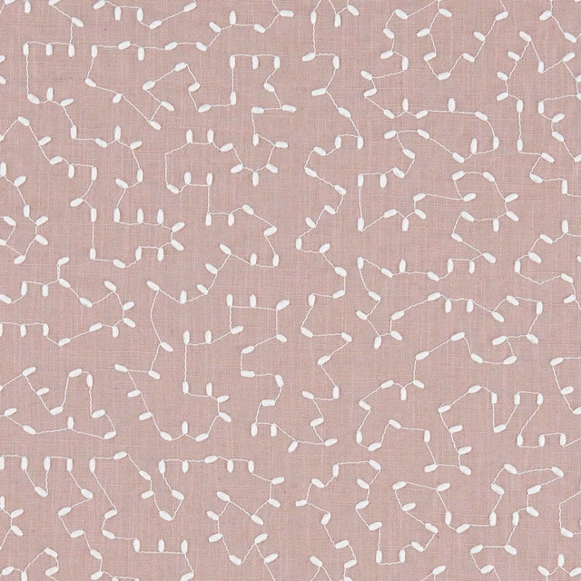 Muted dusty pink woven swatch with scattered white looping linear motifs