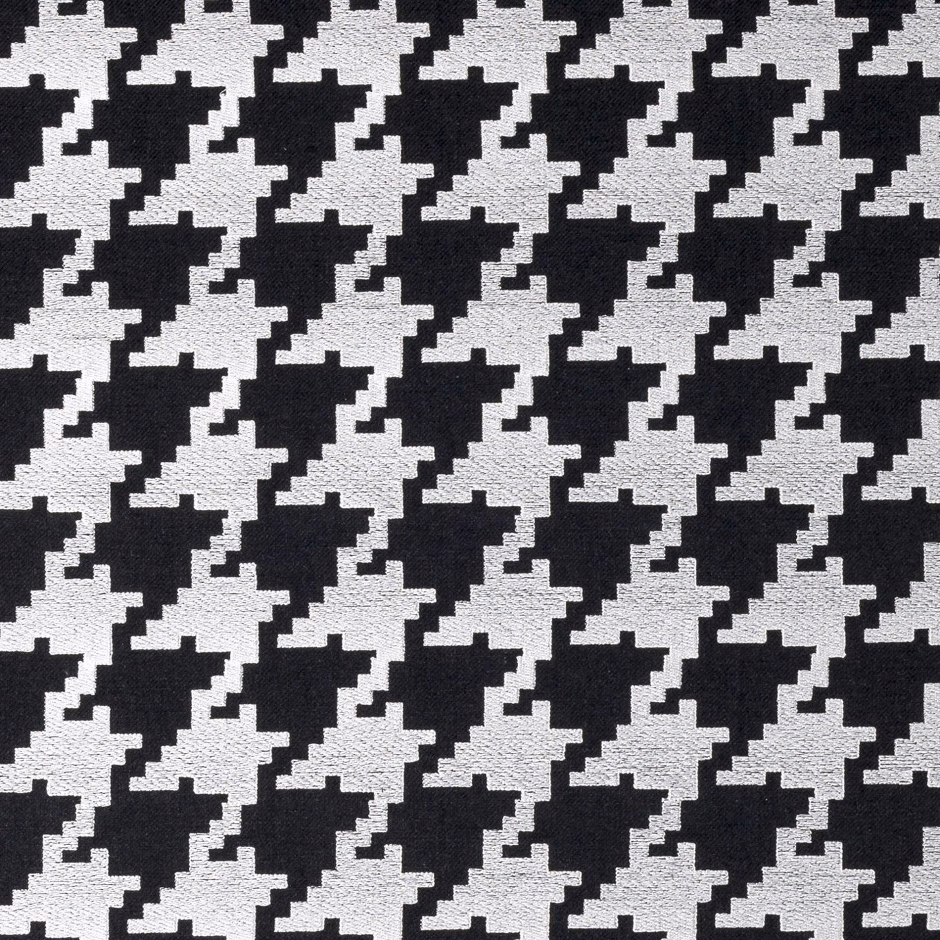 Close-up of black and white woven houndstooth with pixel-edged geometric motifs