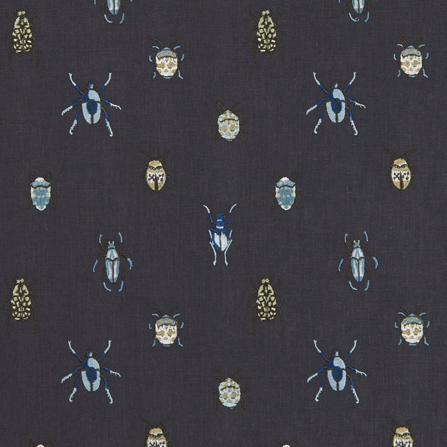 Dark mineral beetle fabric with blue, cream and olive insect motifs on a fine weave