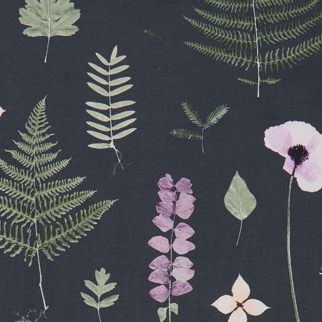 Charcoal botanical fabric with fern fronds, lilac flowers and pale green leaves