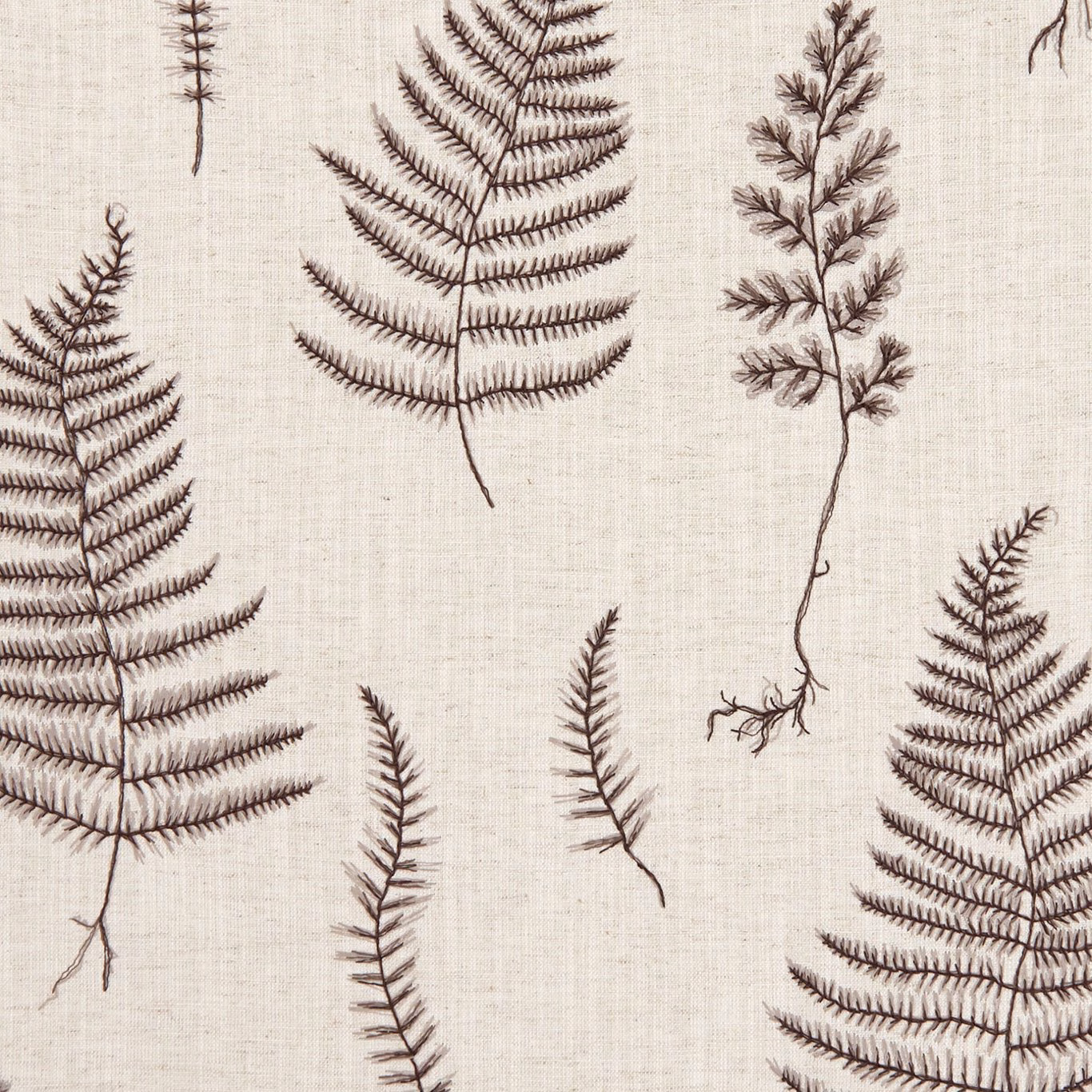 Charcoal fern fronds and seedheads scattered across a textured linen-coloured fabric ground
