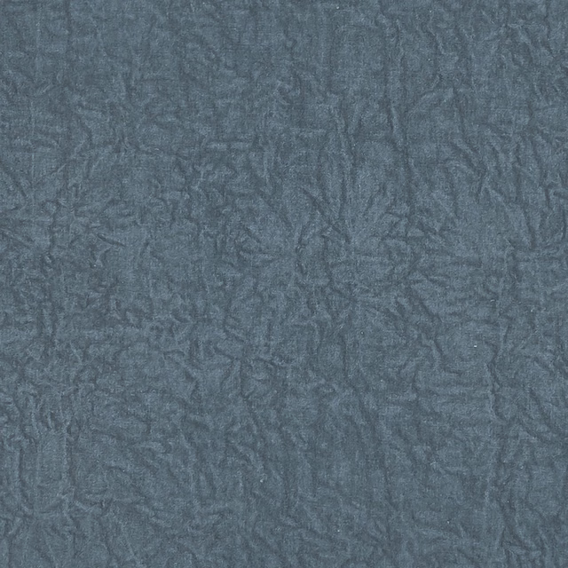 Close-up of Abelia Denim in muted denim blue with crinkled tonal texture
