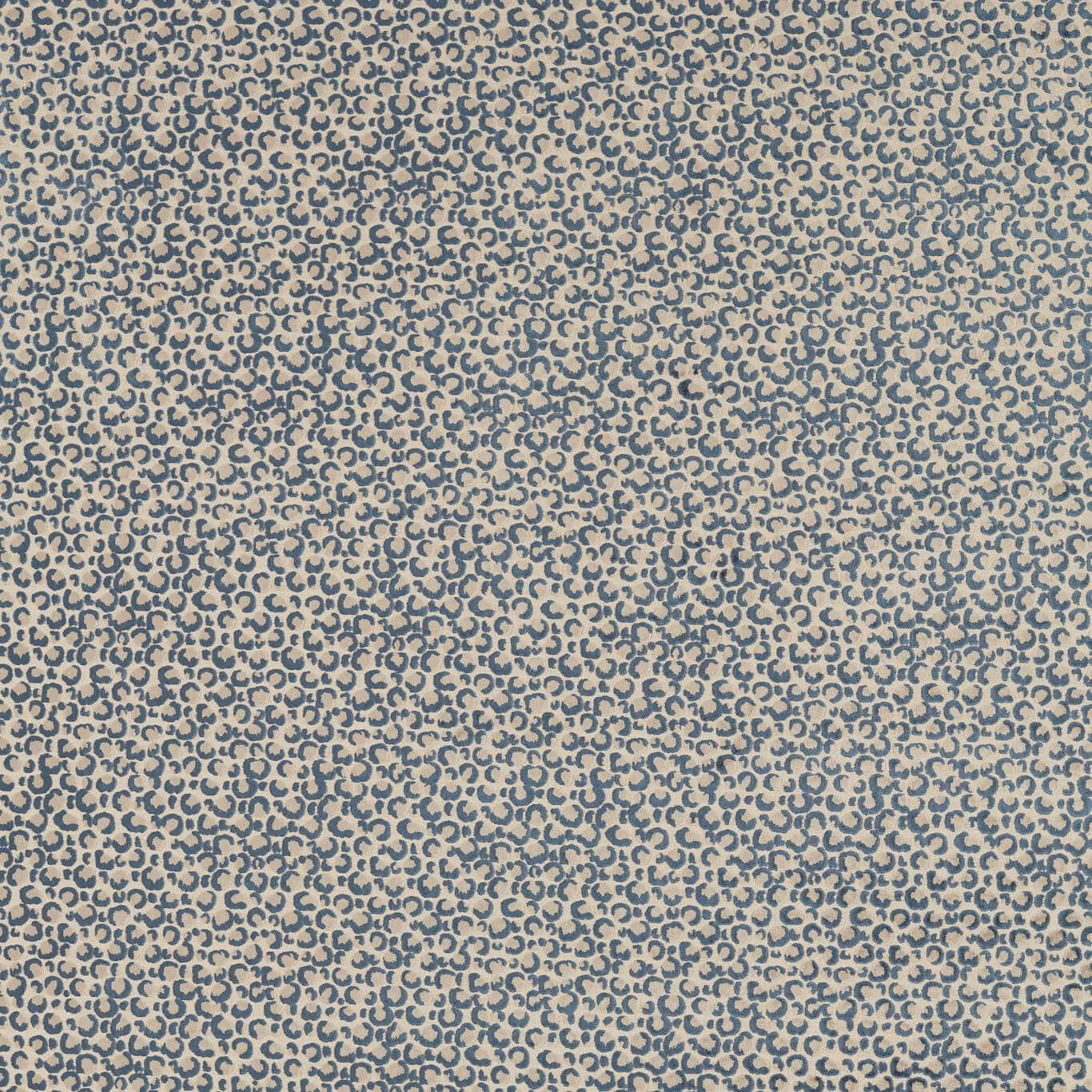 Dense muted denim-blue loop motif woven across a warm stone ground
