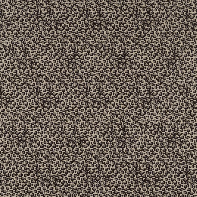 Close-up of dense black ring-like spots woven across a warm taupe ground