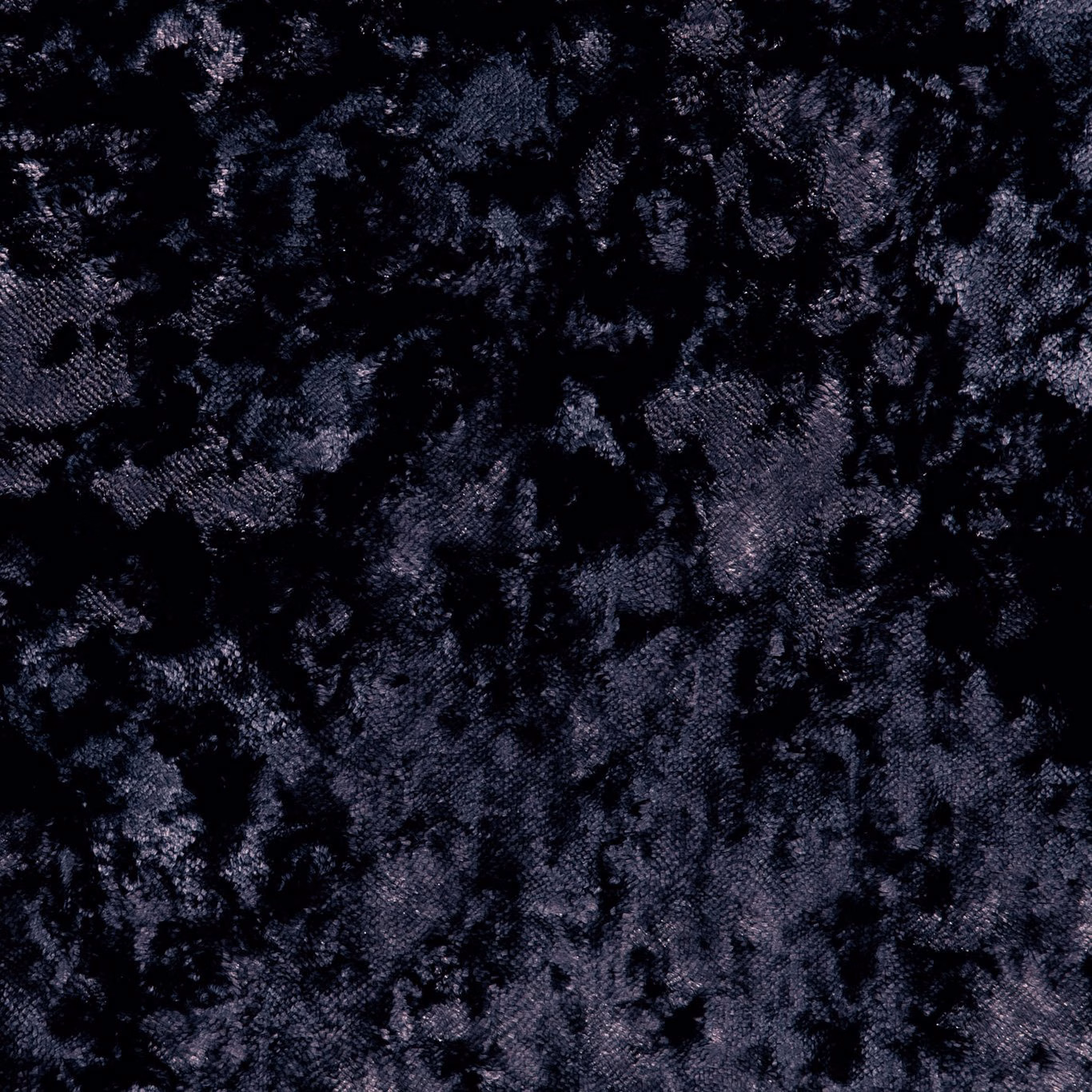 Close-up of deep charcoal black crushed velvet with mottled cool-toned highlights