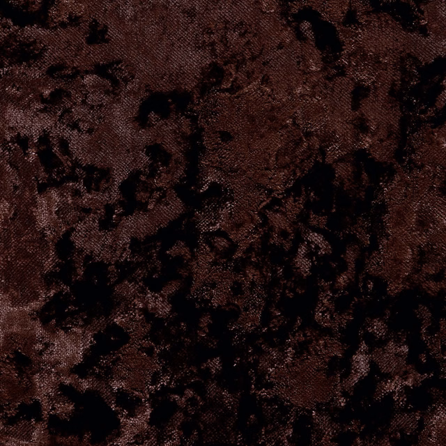 Deep chocolate brown woven fabric with irregular black mottled markings and dense texture