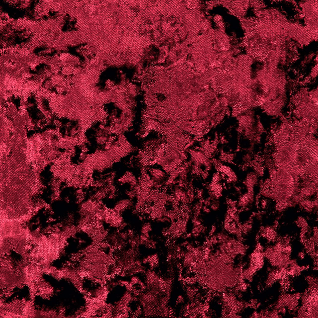 Saturated crimson crushed velvet with irregular black shadowing across the textured pile
