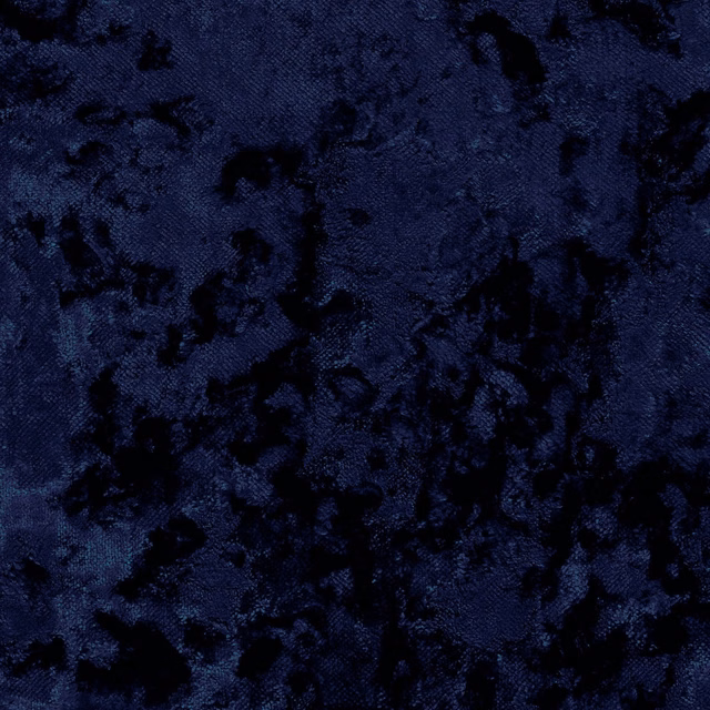 Close-up of midnight navy crushed pile with irregular black mottling and deep texture