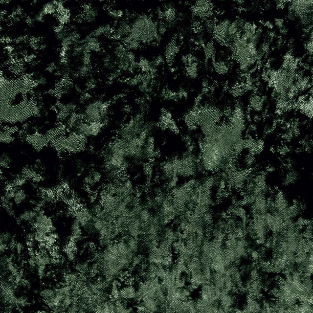 Close view of deep olive fabric with black mottled patches and plush textured surface