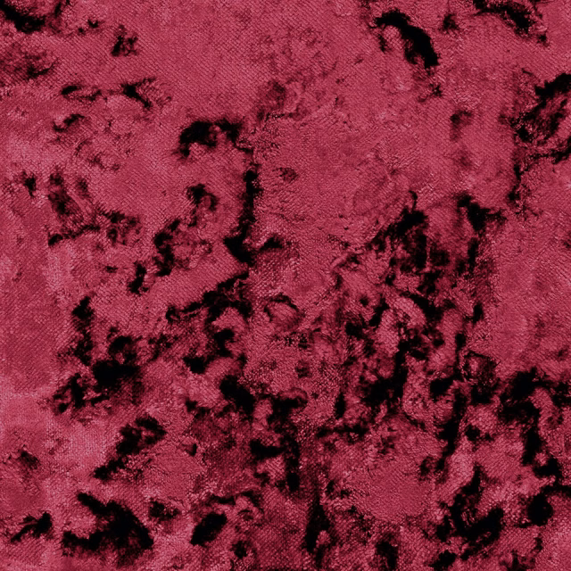 Deep raspberry rose fabric with black crushed, irregular surface marks and directional sheen