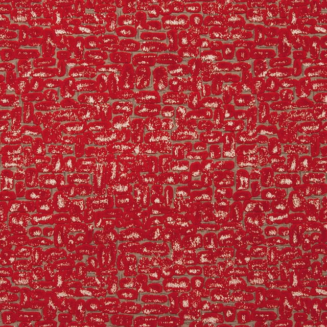 Deep crimson fabric with dense maze-like motifs and distressed pale woven flecks