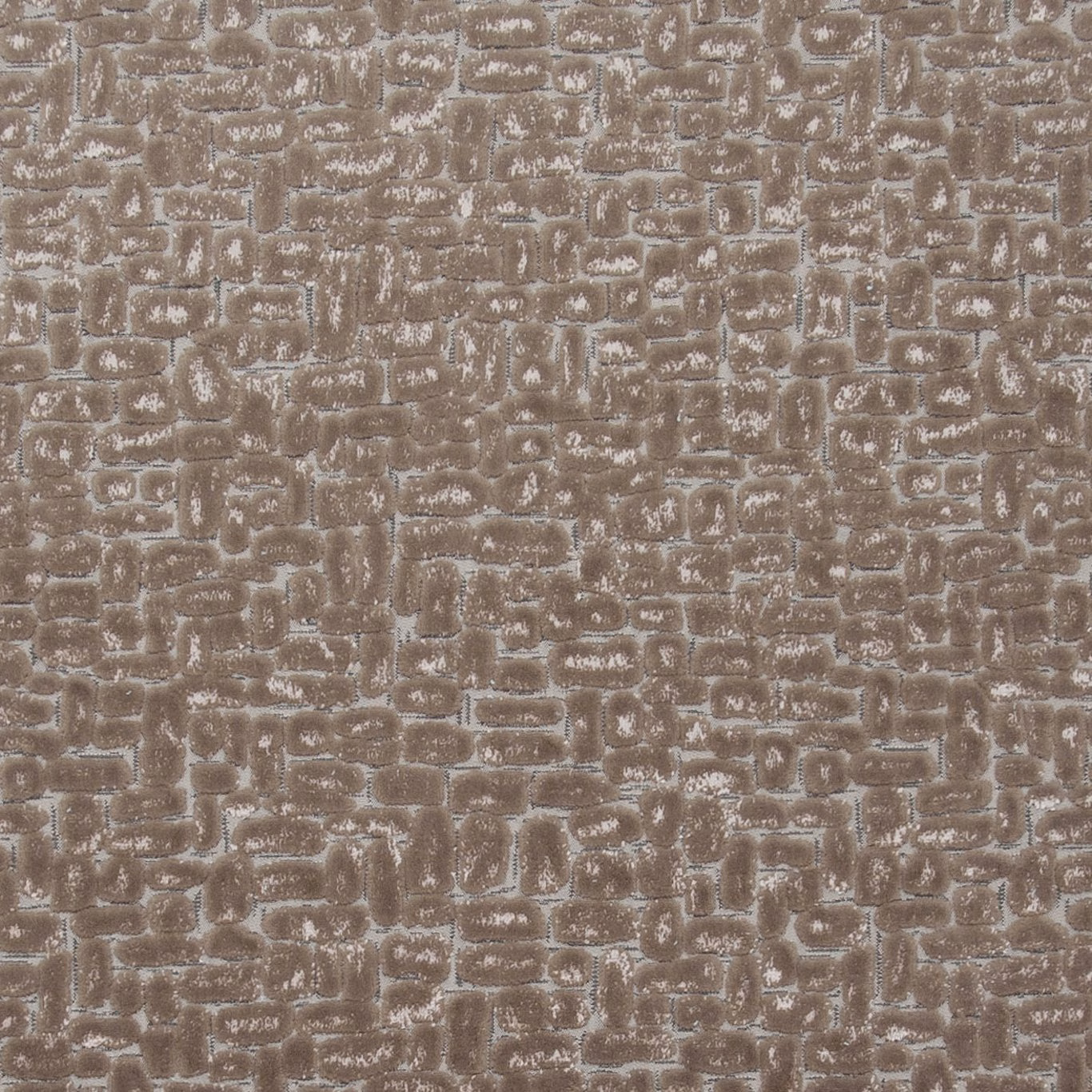 Warm taupe textured fabric with irregular pale-edged geometric blocks and a softly raised surface