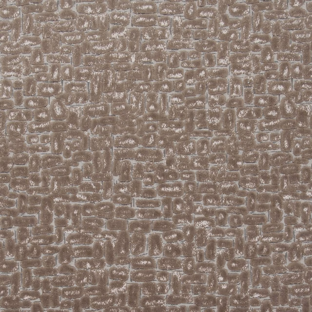 Warm taupe textured fabric with irregular pale-edged geometric blocks and a softly raised surface