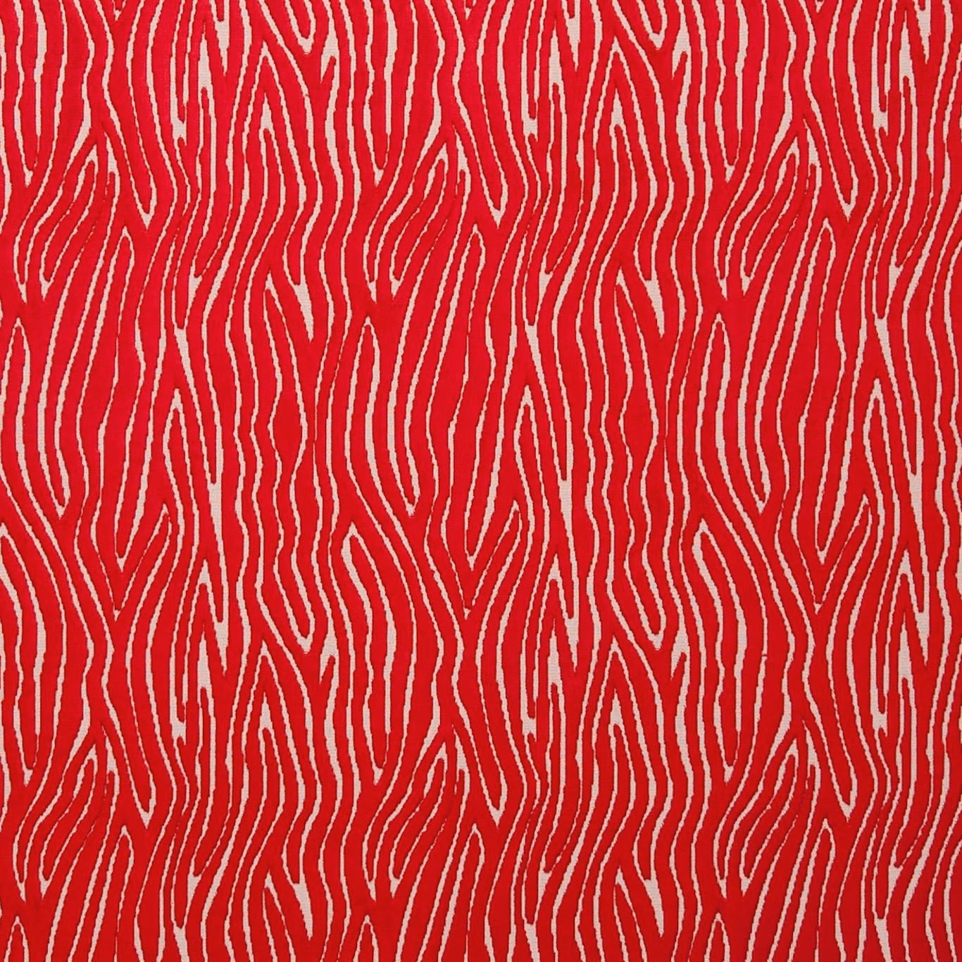 Saturated rouge-red textile with cream irregular vertical flowing lines and textured surface