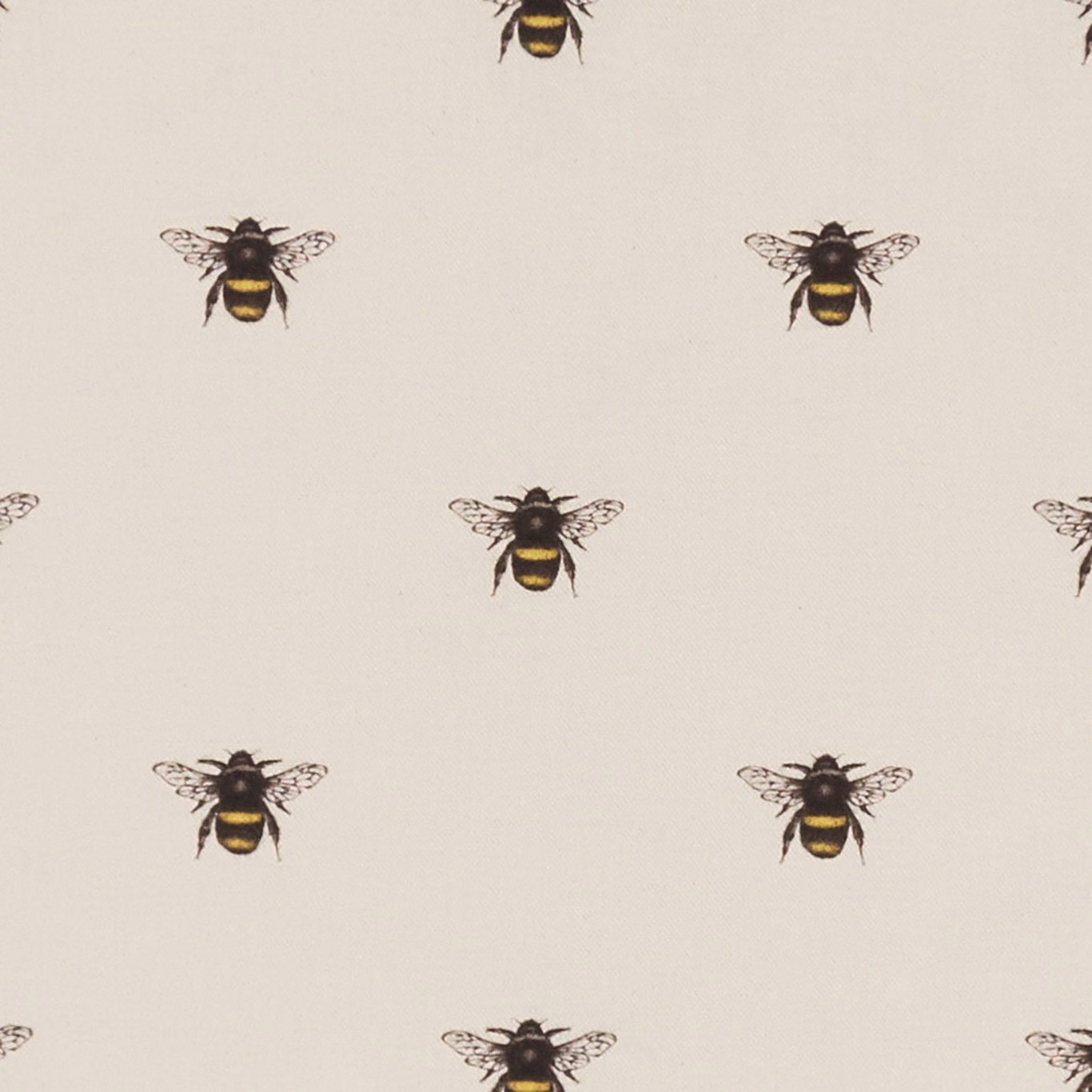 Warm ivory fabric with spaced black-and-gold bee motifs and fine woven texture