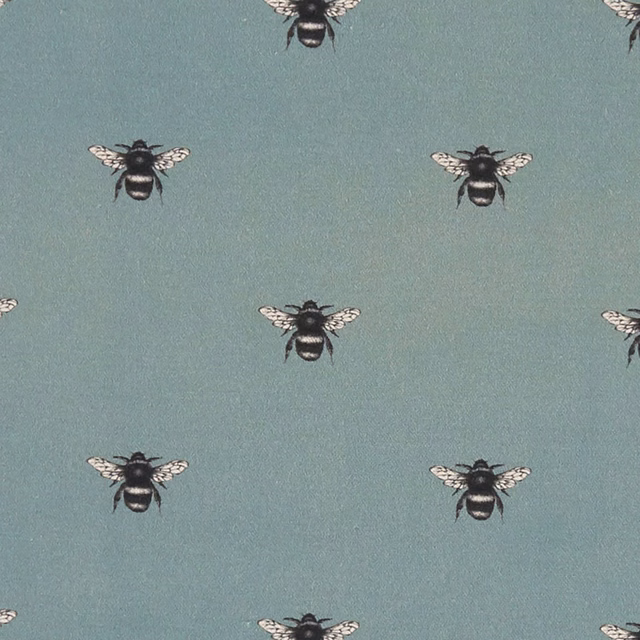 Muted mineral blue-green fabric with evenly spaced black-and-cream bee motifs