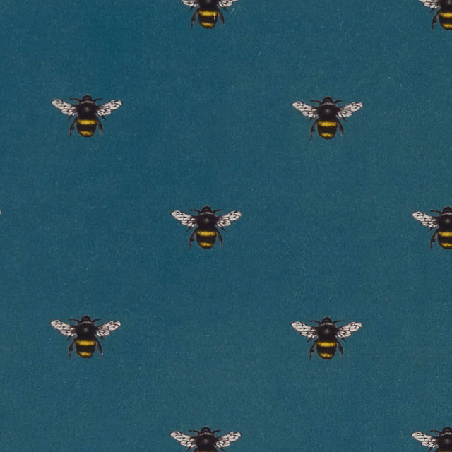 Deep teal fabric with small black-and-yellow bees and pale patterned wings