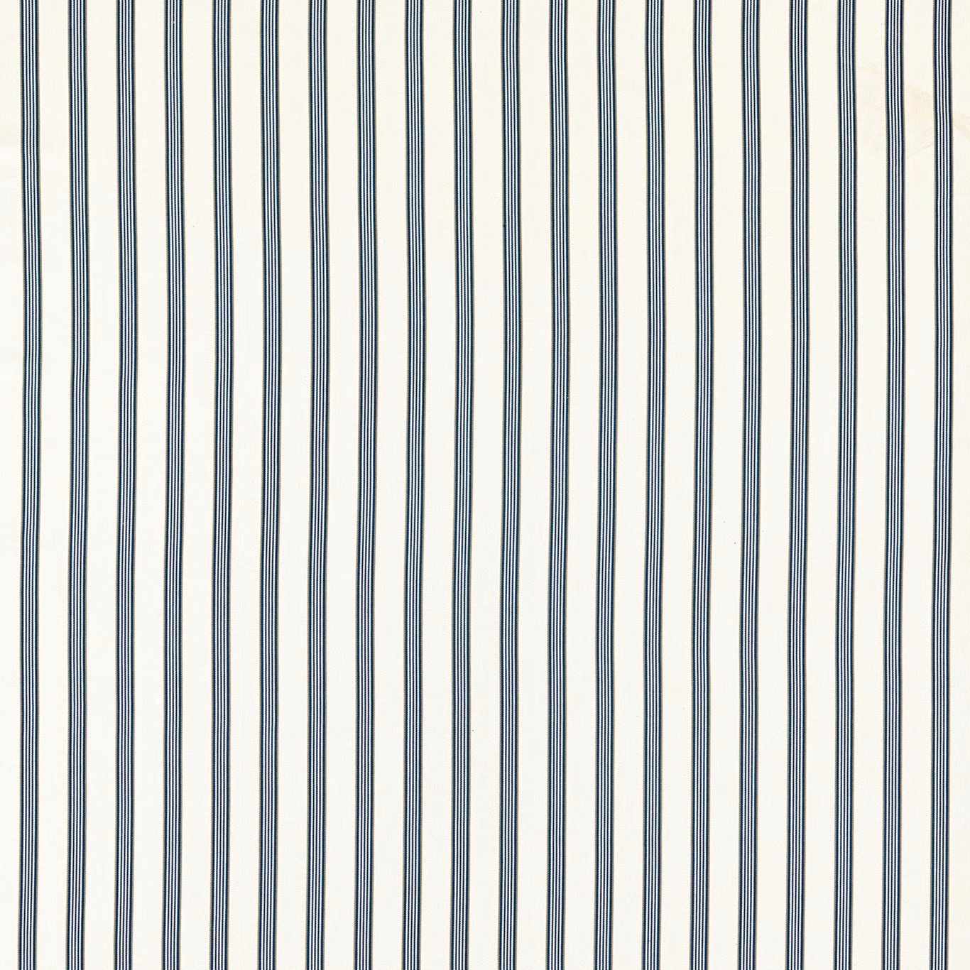 Close-up of fine denim-blue vertical stripes on a softly textured ivory fabric