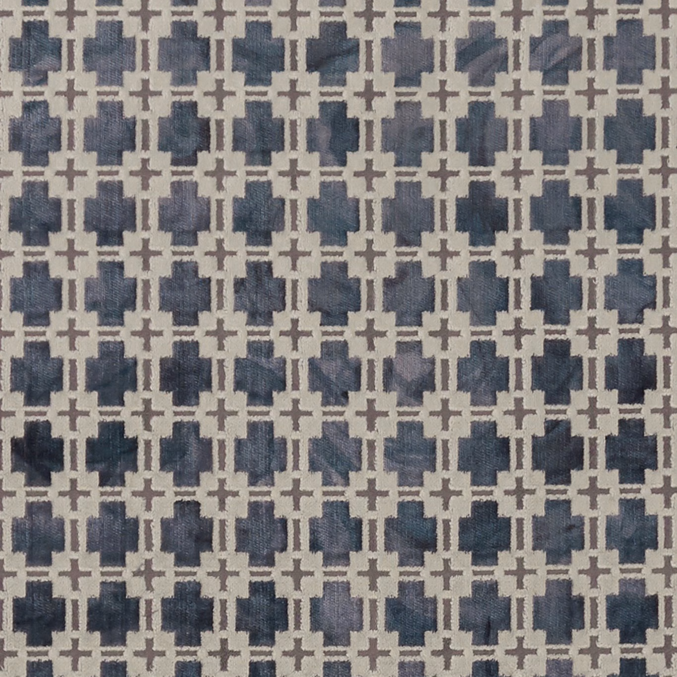 Muted slate-blue woven geometric with cream lattice and irregular charcoal blocks