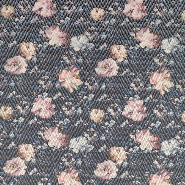 Dusty blush and cream flowers scattered across a textured charcoal woven fabric