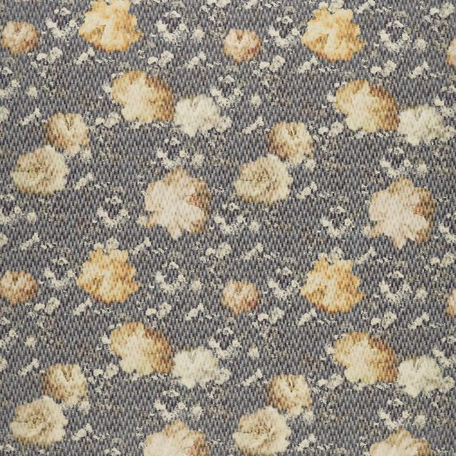 Charcoal woven fabric with muted chartreuse, cream and yellow scattered flowers